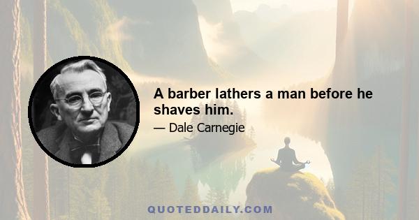 A barber lathers a man before he shaves him.